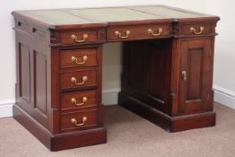 Reproduction mahogany twin pedestal desk fitted with five drawers and single cupboard,