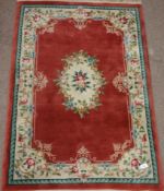 Chinese wash woollen rose colour ground rug,