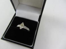 18ct gold ring set with marquise cut central diamond flanked each side by seven graduating square