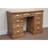 Pine twin pedestal desk fitted with nine drawers, W120cm, H84cm,