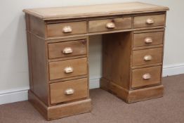 Pine twin pedestal desk fitted with nine drawers, W120cm, H84cm,