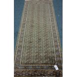 Persian Bokhara design green ground runner rug,