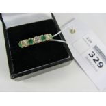 18ct gold ring set with three brilliant cut diamonds and four emeralds Condition Report
