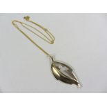 Modernist 9ct gold pendant set with a pearl hallmarked approx 4gm on gold-plated chain stamped 925