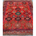 Persian Baluchi red ground rug, repeating Gul design,