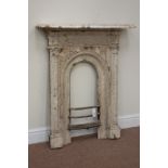 Cast iron fire inset, arched aperture, decorative frieze and upright mouldings, fitted with mantle,