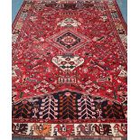 Persian Shiraz hand knotted red ground rug, animal theme, stylized bird and animals,