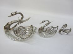 Three graduating German silver-mounted cut glass condiment dishes with hinged wings stamped silver