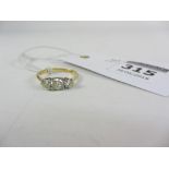 Three stone diamond ring stamped 18ct (centre stone 0.