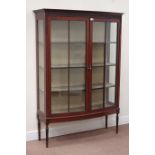 Early 20th century mahogany bow front display cabinet, enclosed by two astragal glazed doors,