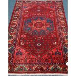 Persian hand knotted Hamadan red ground rug, stylized floral and animal decoration,