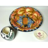 Large tube lined bowl decorated with pomegranates and blueberries,