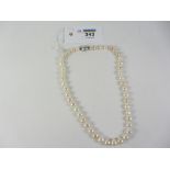 Single row pastel cultured pearls the clasp stamped 750 18" Condition Report <a