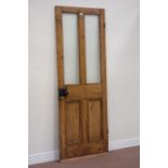 Early 20th century waxed pine door fitted with two glazed panels,