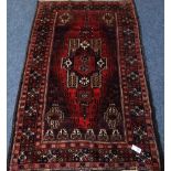 Persian Baluchi red and purple ground rug,