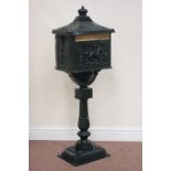 Green aluminium post box with keys and floor bolts, raised on pedestal,