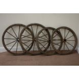 Set four early 20th century wrought metal and rubber bound wheels,