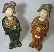 Pair late 20th century Chinese glazed earthenware figures of female courtiers holding lap dogs
