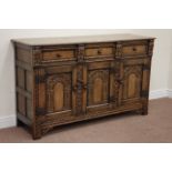 Reproduction Jacobean style medium oak sideboard fitted with three drawers and three cupboards,