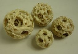 Four graduating 19th century Chinese Canton ivory puzzle balls carved with dragons birds dia.