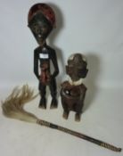 Ivory coast carved wood tribal figure another carved African seated figure and a traditional