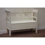 White painted and waxed pine two seat bench fitted with hinged compartment,