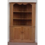 Pine large corner cabinet fitted with three shaped front shelves above double cupboard.