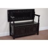 Early 20th century heavily carved oak monk's bench fitted with hinged seat enclosing storage