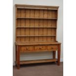 Waxed pine three drawer dresser fitted with under tier and three heights plate rack above, W149cm,