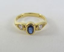 Gold rub over oval Sapphire and Diamond three stone ring hallmarked 18ct Condition Report