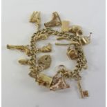 Gold curb chain charm bracelet hallmarked 9ct with 17 charms mostly hallmarked 9ct,