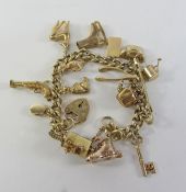 Gold curb chain charm bracelet hallmarked 9ct with 17 charms mostly hallmarked 9ct,