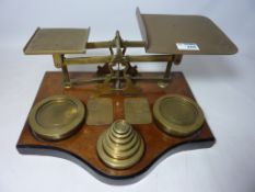 Large set of early 20th Century Postal Scales with weights on walnut base Condition