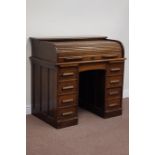 Early 20th century oak twin pedestal tambour roll top desk, fitted with eight drawers and slides,