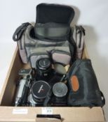 Canon AE-1 SLR camera with 24-48mm lens and 135mm lens, Nikon F50 with 35-80mm lens,