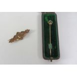 Victorian gold lozenge broach set with a diamond stamped 9ct and a Victorian stick pin,