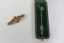 Victorian gold lozenge broach set with a diamond stamped 9ct and a Victorian stick pin,