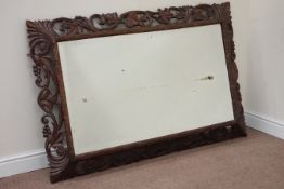 20th century carved oak rectangular mirror fitted with bevelled edge glass,