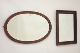 Oak framed rectangular mirror with bevelled edge glass and an oval bevelled edge mirror in oak