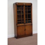Early 20th century oak bookcase enclosed by two glazed doors, above double cupboard, W81cm, H154cm,