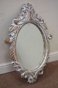 Ornate painted French style oval wall mirror,