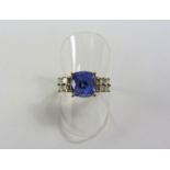 Lorique gold tanzanite ring each shoulder set with four princess cut diamonds hallmarked 18ct