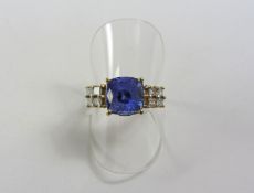 Lorique gold tanzanite ring each shoulder set with four princess cut diamonds hallmarked 18ct