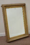 Ornate relief moulded gilt wood and gesso rectangular mirror fitted with bevel edged glass,