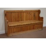 Waxed pine bench/pew, panelled back, fitted with hinged seat enclosing storage compartment,