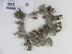 Hallmarked silver curb chain bracelet with various charms approx 2oz gross Condition