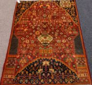 3297 Shiraz rug, with all over floral design over red ground, arched Mihrab,