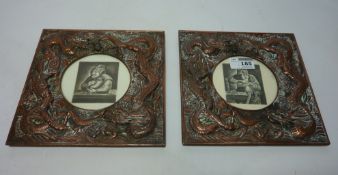 A pair of Chinese copper picture frames decorated with dragons with signed etchings