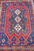 Persian rug, with triple cruciform diamonds, over blue ground , various striped and floral boarders,