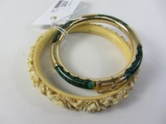 Gold mounted malachite hinged bangle and an early 20th century carved ivory bangle